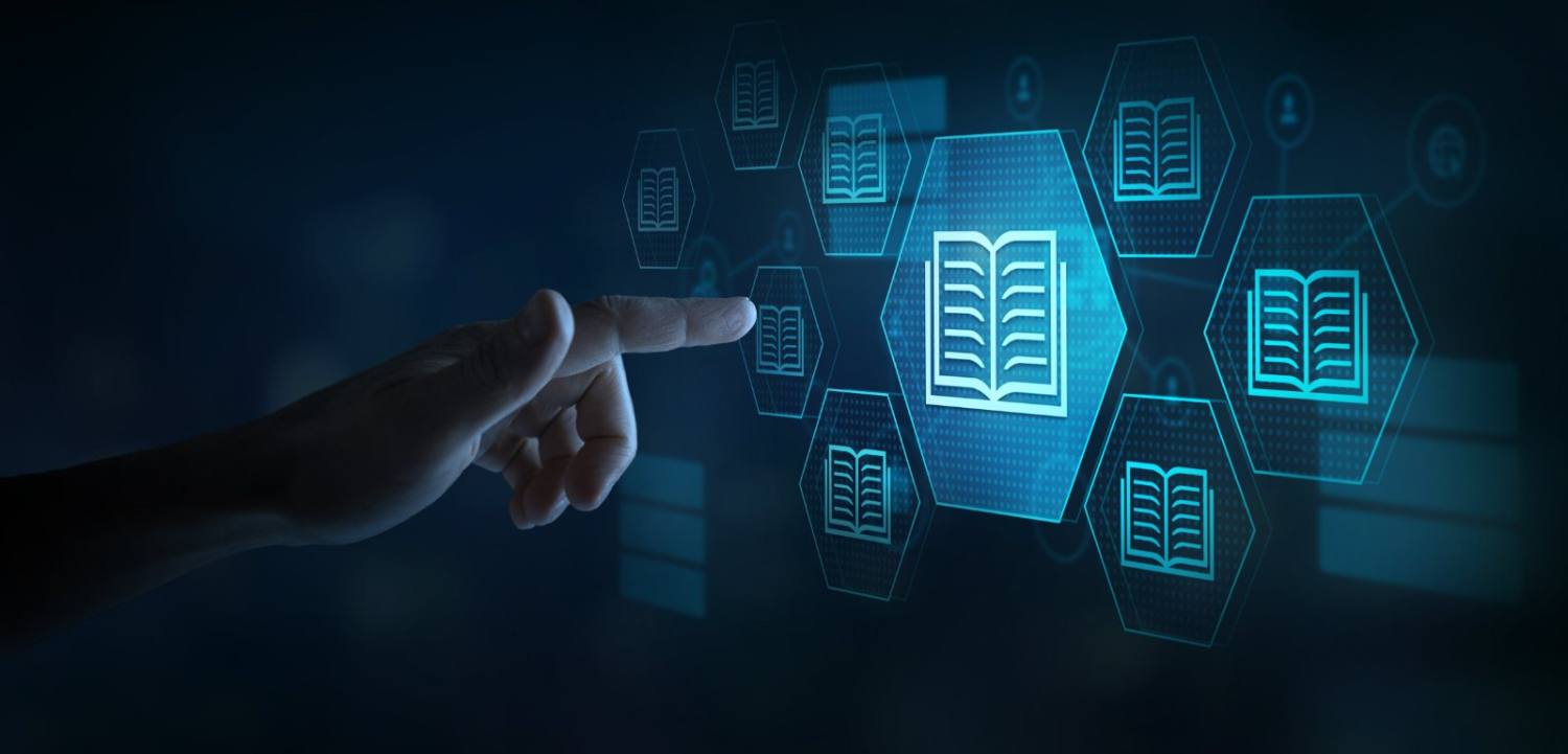 Hand pointing at glowing blue book icon among interconnected hexagonal network nodes